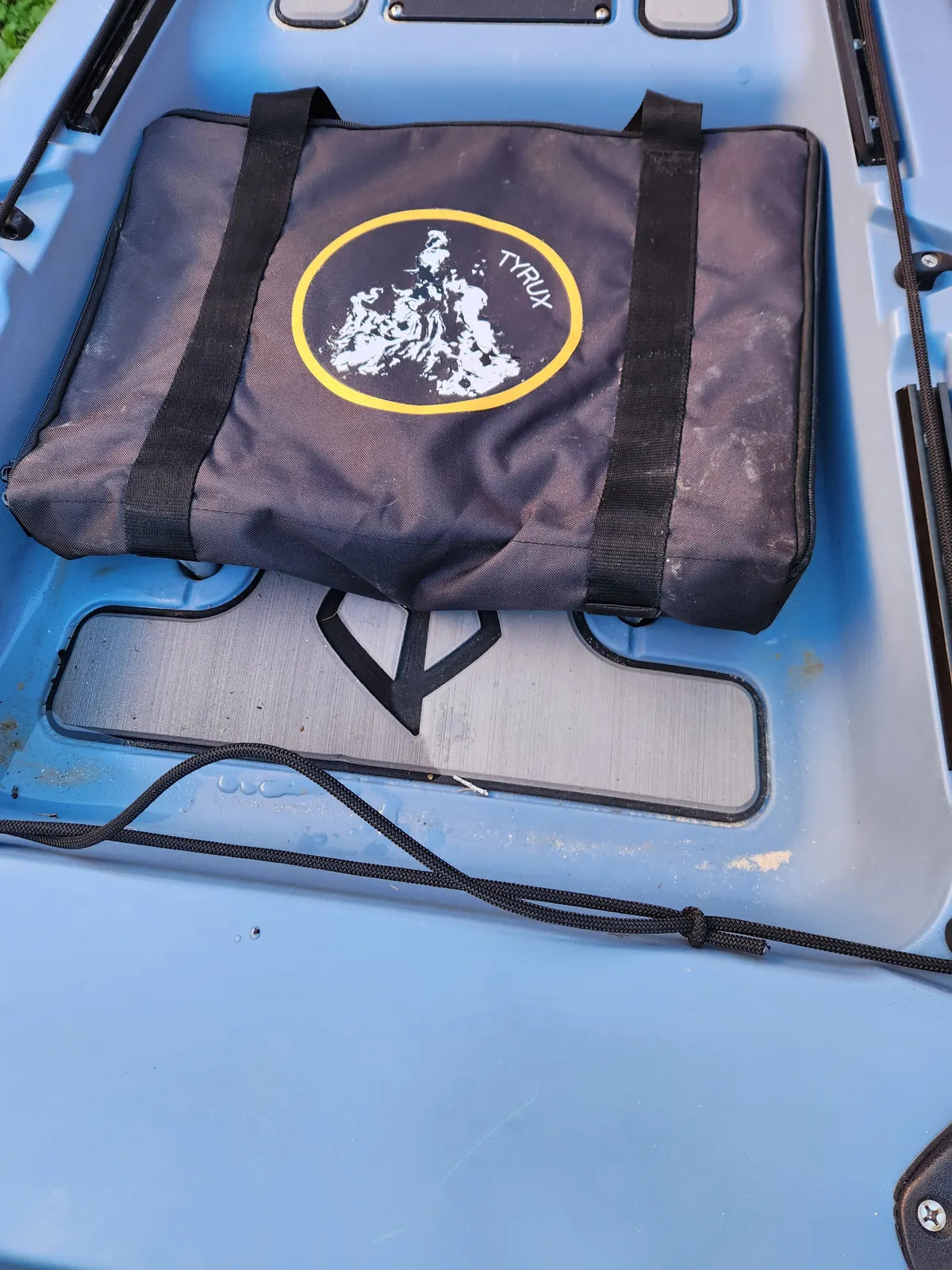 Tyrux Campfire Grill packed in its carry bag on a kayak